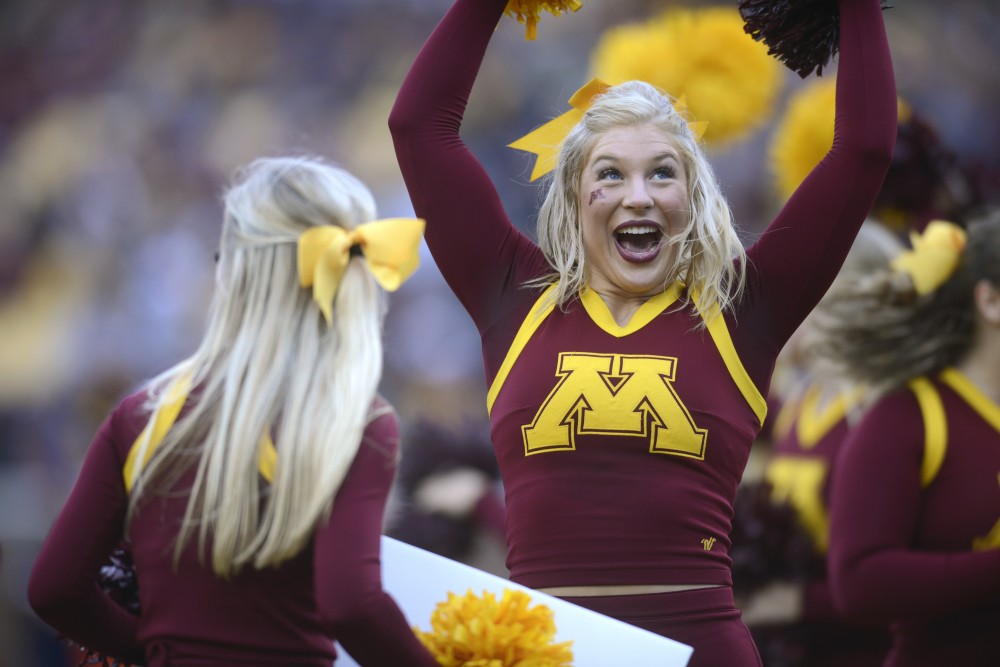 Gophers Small Co-Ed Cheer Team member Sydney Samborski encourages the crowd and the team on Saturday, Oct. 21 at TCF Bank Stadium. The Gophers defeated Illinois 24-17 during the homecoming game.