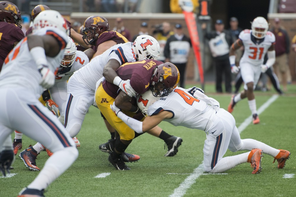 Rodney Smith takes a blow at the homecoming game against Illinois at TCF Bank Stadium on Saturday, Oct. 21.
