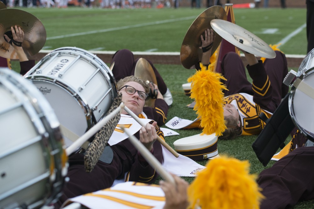 Gophers marching band members take a rest during the third quarter of the homecoming game on Saturday, Oct. 21 at TCF Bank Stadium. 