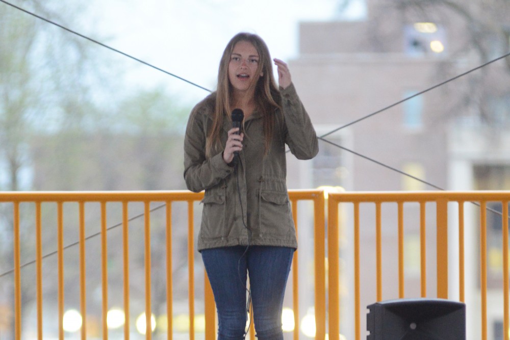 Sexual assault advocate Abby Honold speaks to a crowd on East Bank on April 18.