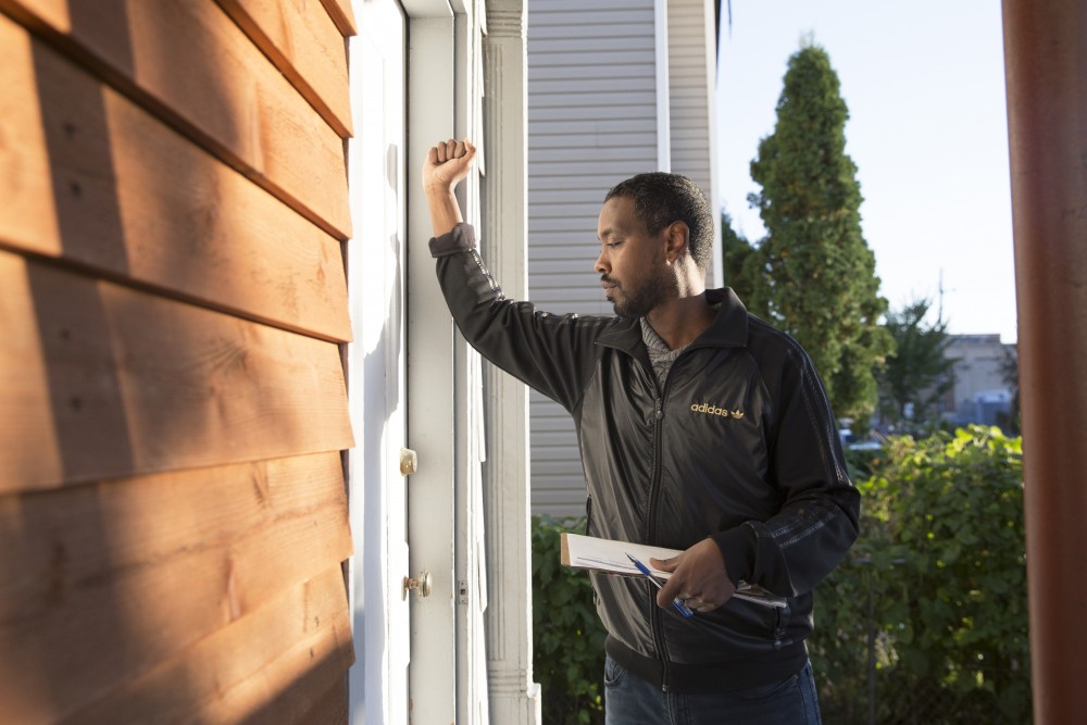 Ward 6 City Council Member Abdi Warsame knocks on doors of community members on Saturday, Oct. 14 in Minneapolis. Warsame is running for his second term as a city council member.