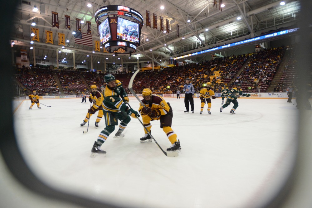 Freshman forward Scott Reedy attempts to steal the puck from Clarkson at 3M Arena at Mariucci in Minneapolis on Saturday, Oct. 28. 