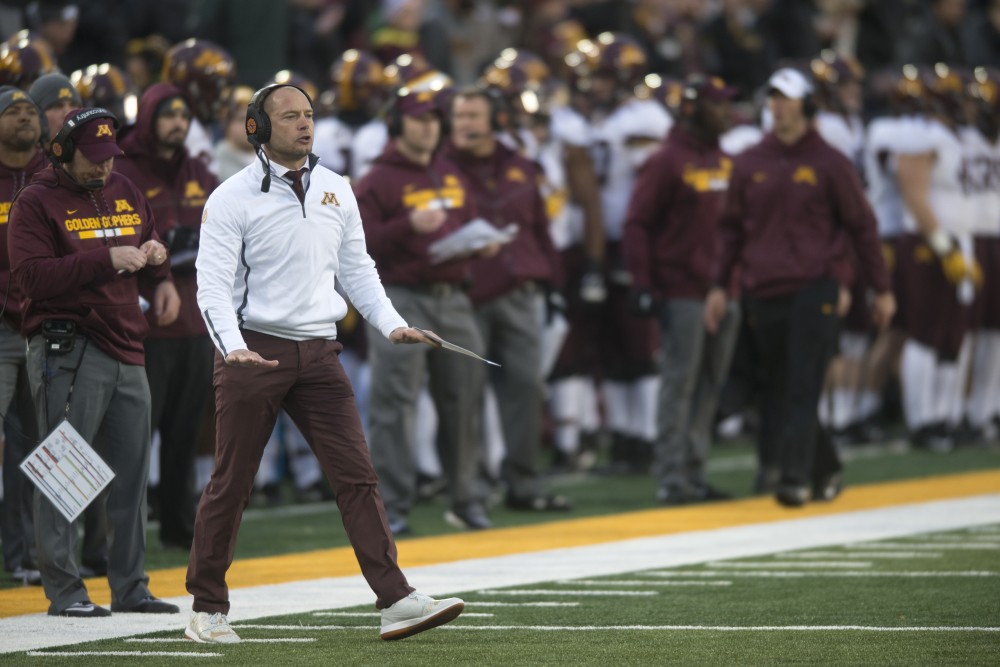 Head coach P.J. Fleck and his staff stand along the sideline at Kinnick Stadium on Saturday, Oct. 28.
