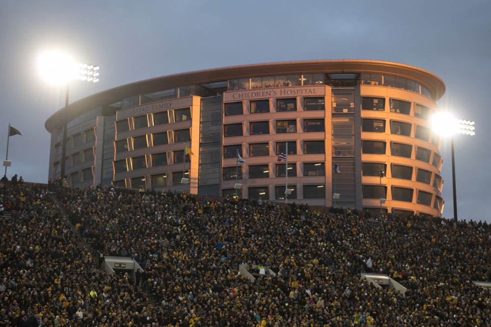 Football fans watch the game from University of Iowa Stead Family Childrens Hospital behind Kinnick Stadium on Saturday, Oct. 28.