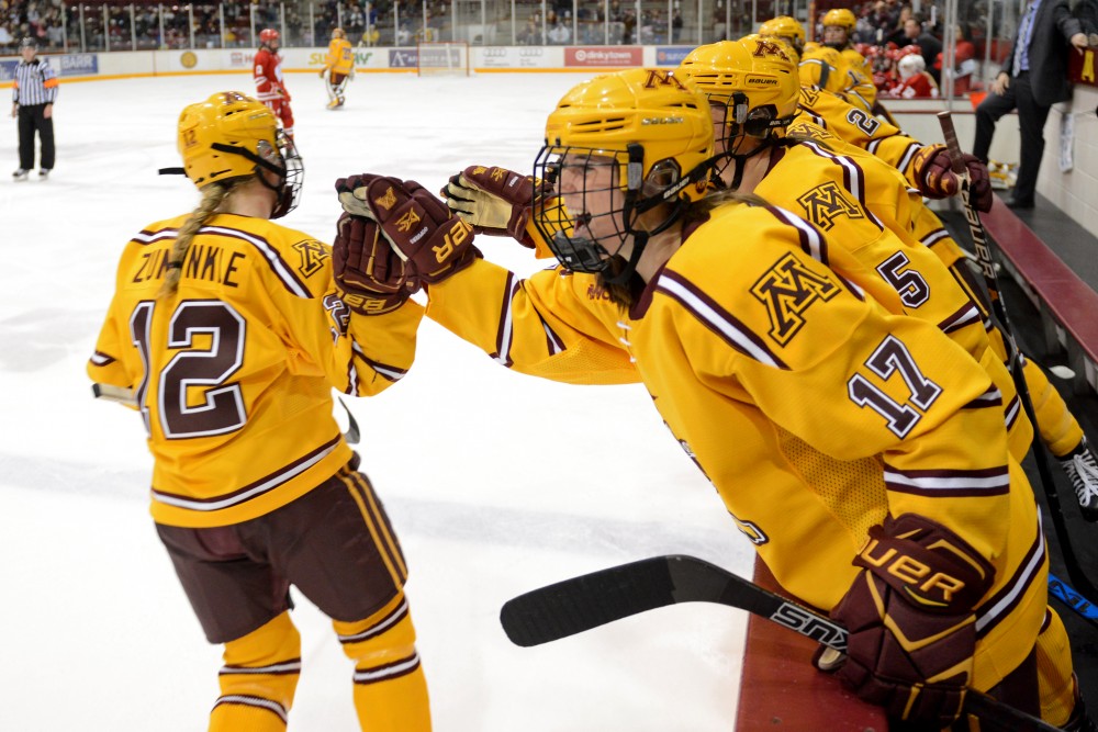Freshman forward Grace Zumwinkle is cheered on by her team after she scores in the second period at Ridder Arena on Sunday, Oct. 29.  