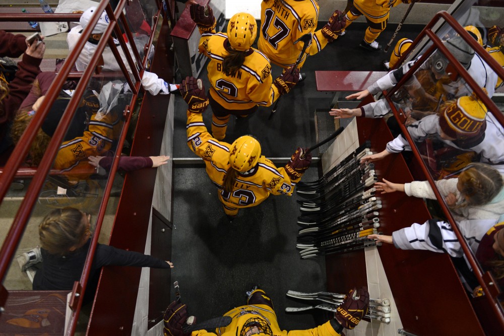 Gopher fans line up for high-fives as the Gophers Womens hockey teams enters the ice a Ridder Arena on Sunday, Oct. 29. 