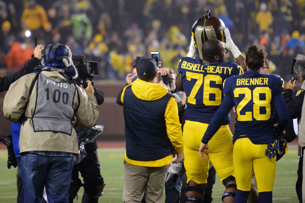 Michigan players hold up the Little Brown Jug after winning against the Gophers 33-10 on Saturday, Nov. 4, 2017 in Ann Arbor, Mich. 