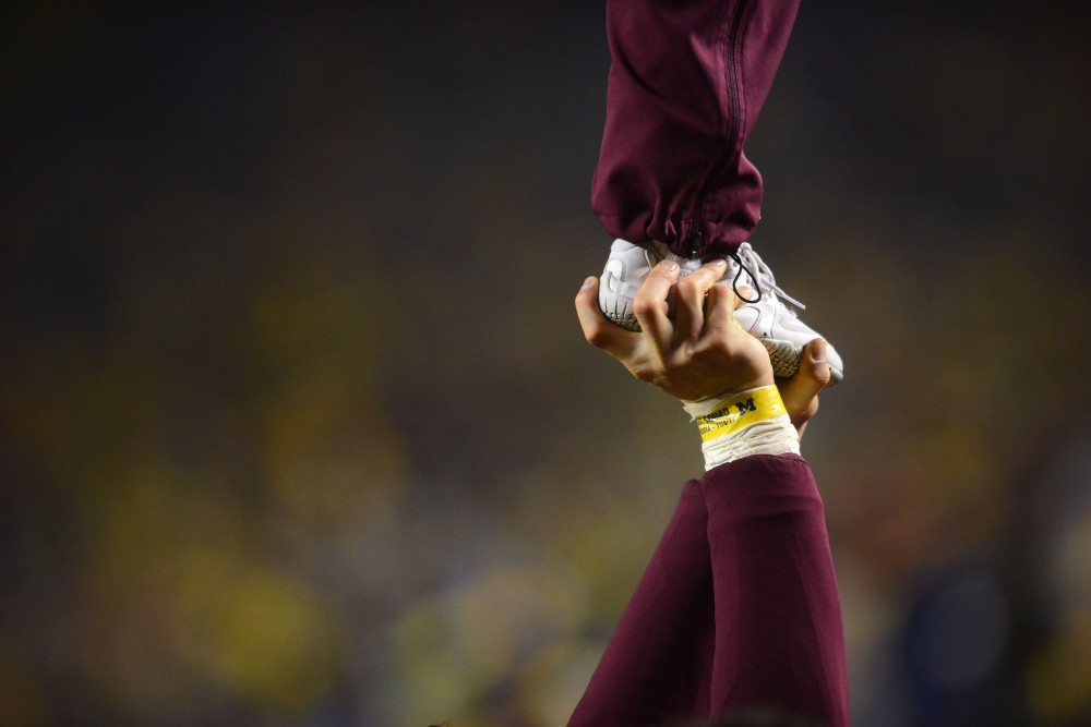 Minnesota cheerleaders perform a stunt during the game against Michigan on Saturday, Nov. 4, 2017 in Ann Arbor, Mich.