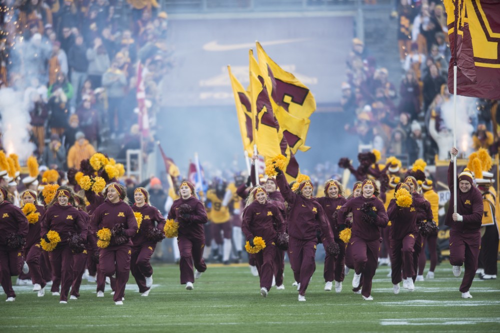 Minnesota Cheerleaders run onto the field at TCF Bank Stadium on Saturday, Nov. 11.