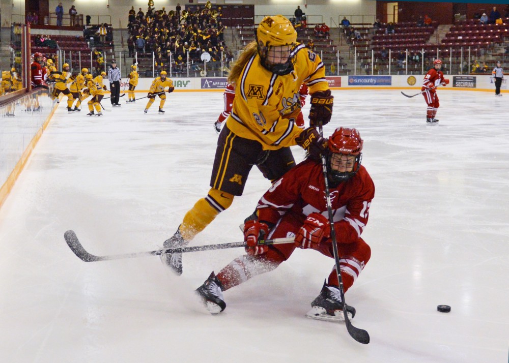 Forward Alex Woken goes after the puck during the Gophers game against Wisconsin at Ridder Arena on Sunday, Oct. 29.