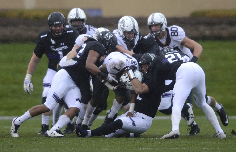 Rodney Smith gets tackled by Northwestern players on Saturday, Nov. 18 at Ryan Field in Evanston, Illinois.