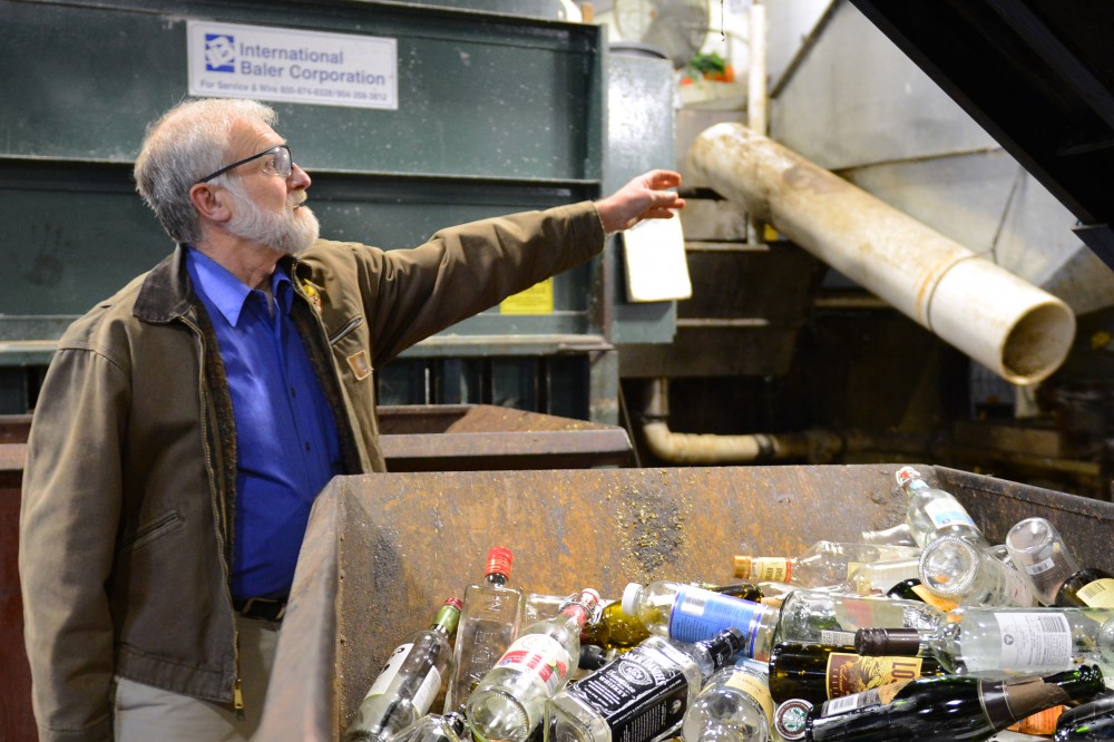 Facilities Support Supervisor Dana Donatucci sorts recycled bottles into the correct receptacle at the Como Recycling Facility on Tuesday, Nov. 7 in Minneapolis. Donatucci has managed the facility for 30 years. 