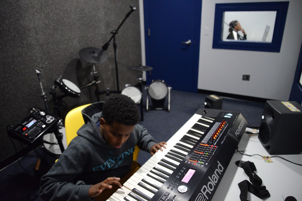 Abdijabar plays on a keyboard inside a new recording booth at the teen tech center at the Brian Coyle Center in Minneapolis on Tuesday, Nov. 21.