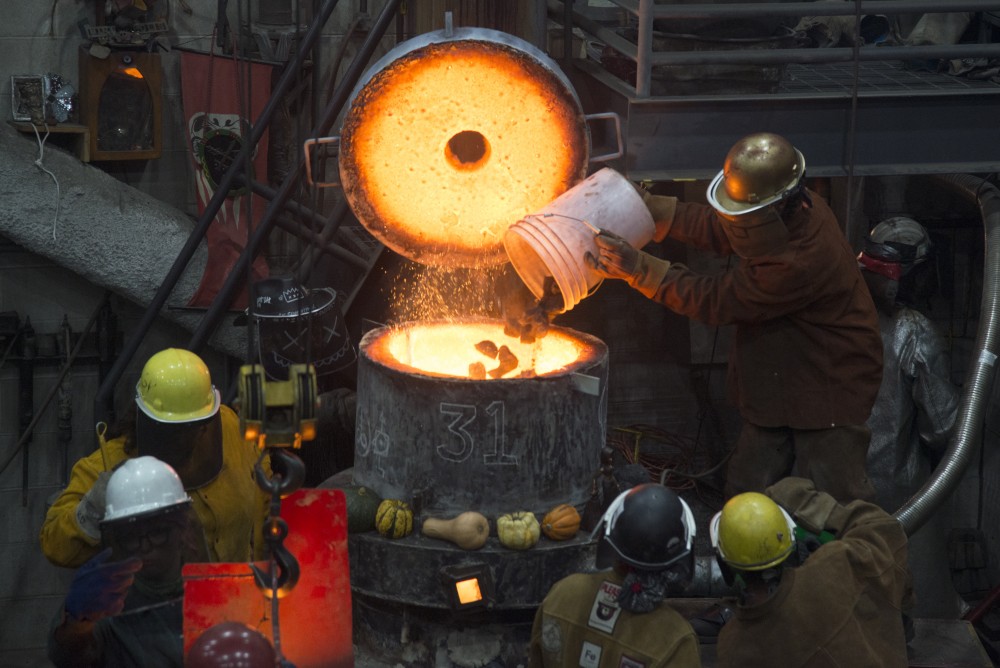 Participants engage in the Universitys Art Departments 31st annual Iron Pour at the Regis Foundry on Tuesday, Nov. 21.