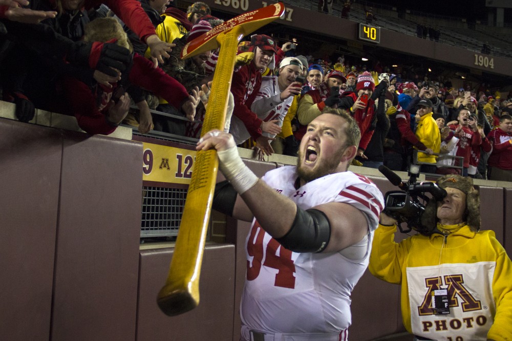Badgers defensive end Matt Henningsen celebrates the victory with fans at TCF Bank Stadium on Saturday, Nov. 25. The Badgers defeated the Gophers 31-0.