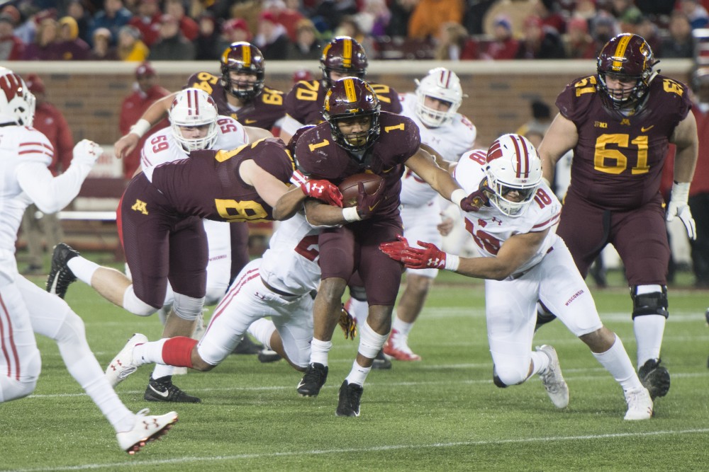 Gophers running back Rodney Smith rushes with the ball at TCF Bank Stadium on Saturday, Nov. 25. The Badgers defeated the Gophers 31-0.