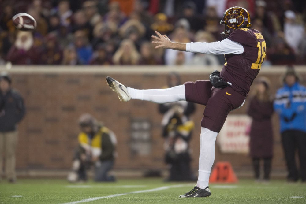 Kicker Ryan Santoso punts the ball during the game against Wisconsin on Saturday, Nov. 25 at TCF Bank Stadium. The Badgers beat the Gophers 31-0.