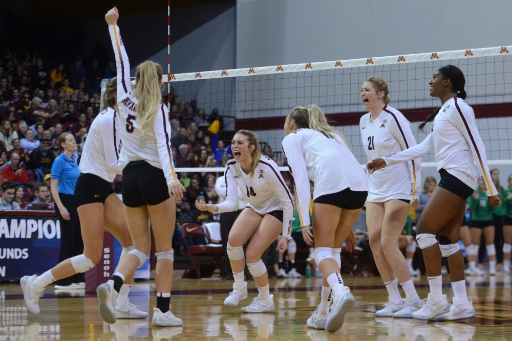 The Gophers volleyball team celebrates scoring a point on the Fighting Hawks at Maturi Pavilion on Friday, Dec. 1. 