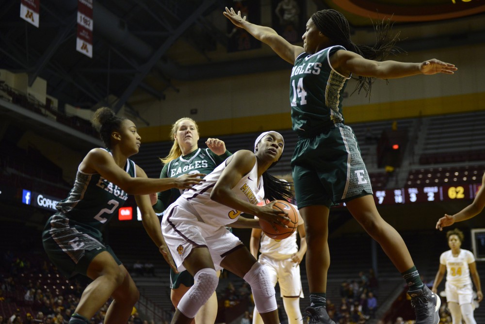 Sophomore forward Taiye Bello avoids a block during a game against East Michigan on Sunday Dec. 3 at Williams Arena. 