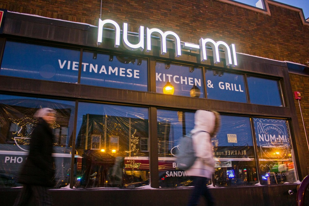 Pedestrians pass by Num-Mi in Dinkytown Tuesday, Dec. 5. The owners hope to open early next year.
