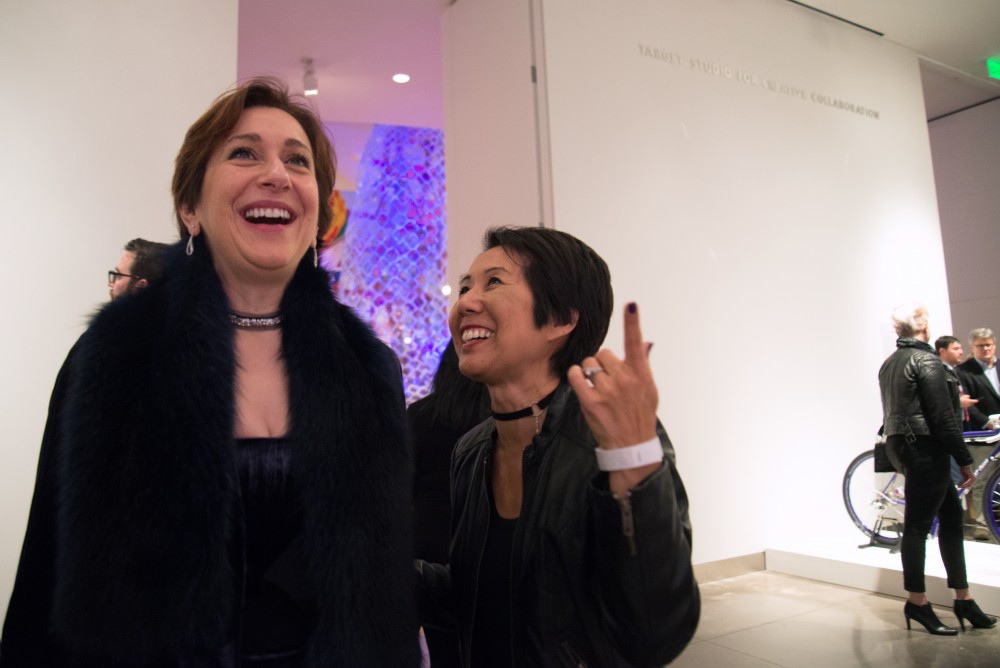 Shirin Saadat, left, and Kim Tsujimoto get their first glimpse of Rock Martinezs larger-than-life mural of Prince during the preview party for the Weisman Art Museums Prince from Minneapolis exhibition on Friday, Dec. 8. 