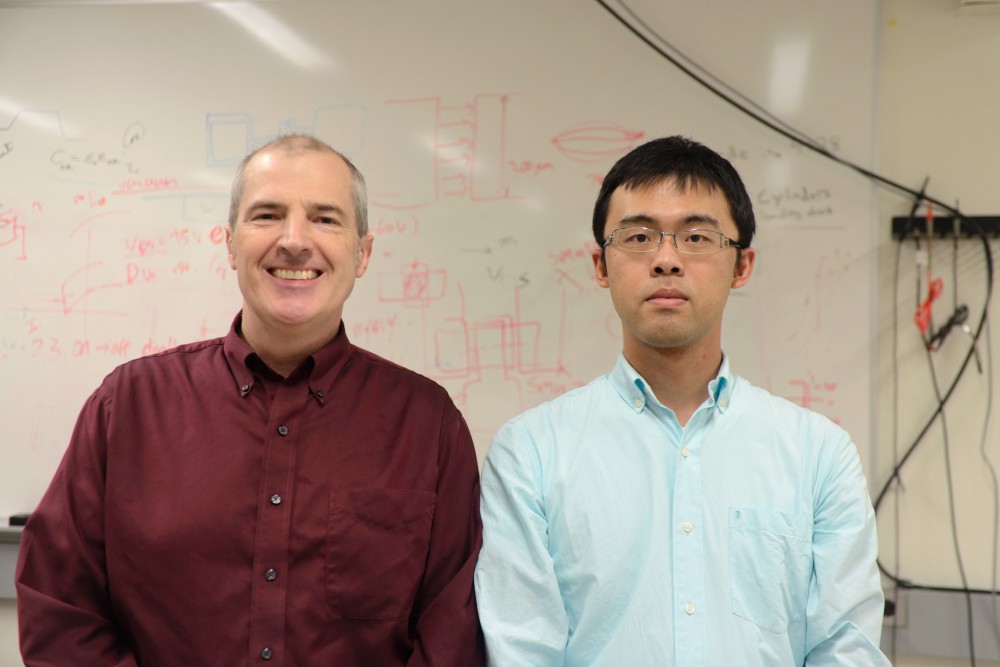 Professor Steven Koester, left, and grad student Yao Zhang pose for a photo in a lab in Kenneth H. Keller Hall on East Bank on Tuesday, Dec. 12.