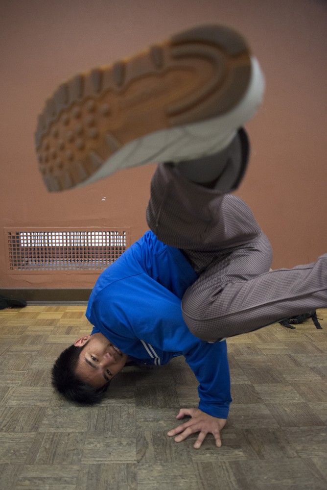 Leroy Panyathip poses for a portrait in a break dance move during practice in Peik Gymnasium. Leroy has been breakdancing since he started college two years ago. 