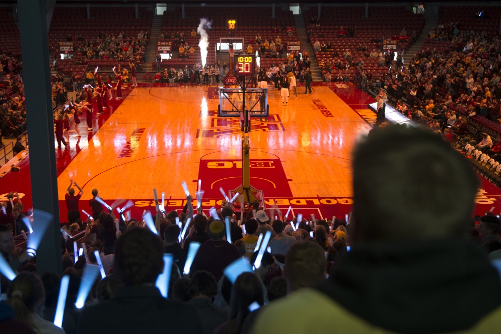 Students hold light sticks for a light out before the womens basketball game against Wisconsin on Thursday.  University of Minnesota sororities asked members to attend the game to raise attendance and awareness of Gopher womens sports, with more than 300 attending in response. 