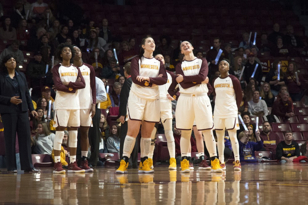 The Gopher womens basketball team watches a replay during the game against Iowa at Williams Arena on Sunday.