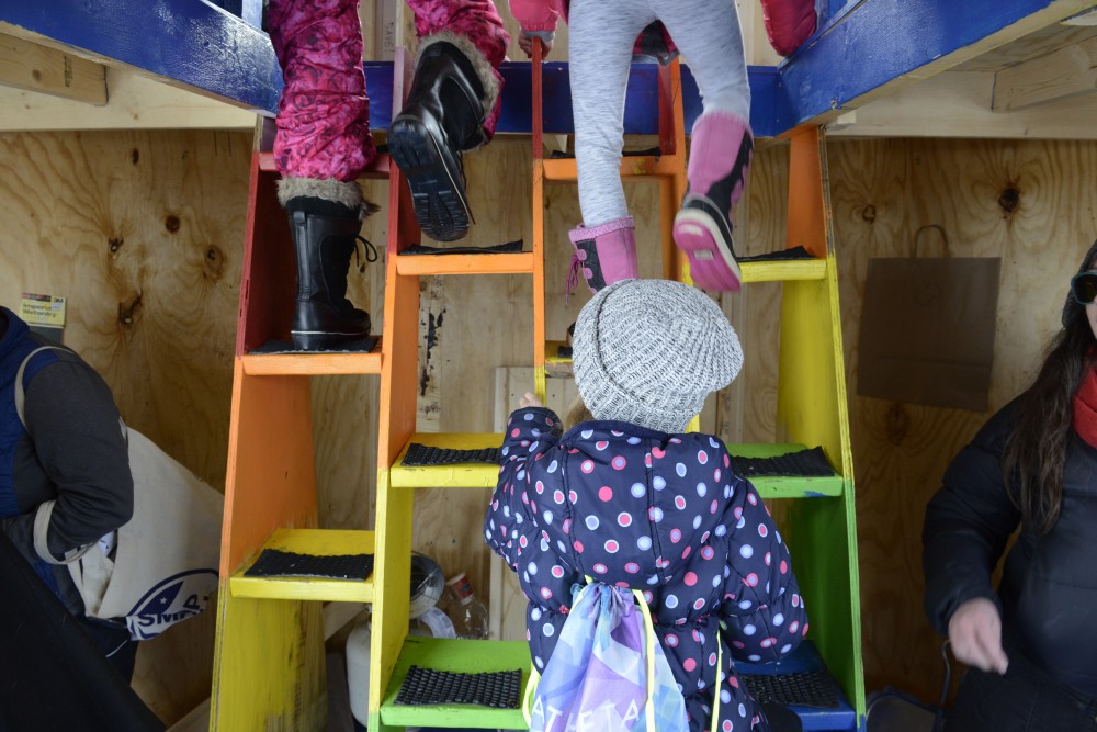 Children climb to the upper level of the Fyr Minnesåta shanty by the artist collective Teens from Leonardos Basement on Lake Harriet in Minneapolis on Saturday, Jan. 20 