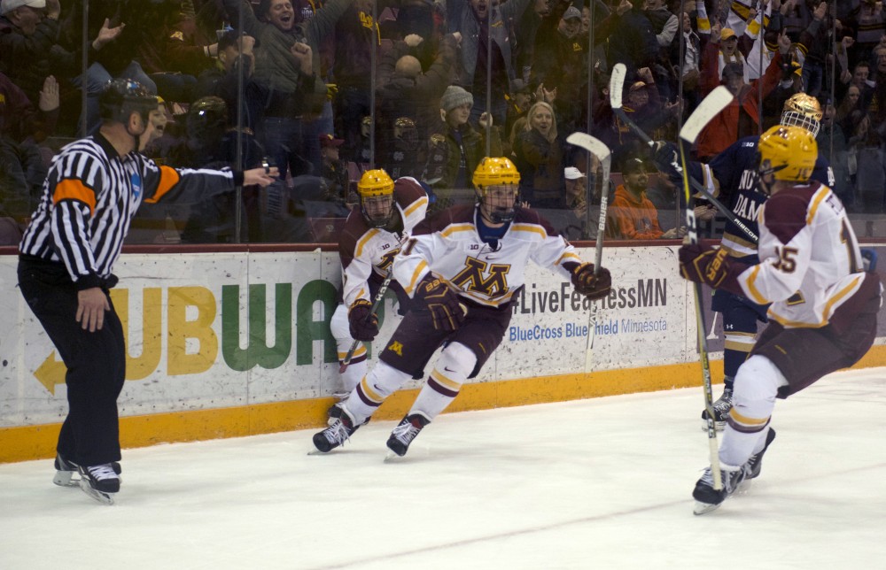 Forwards Casey Mittlestadt and Brannon McManus bounce back from the boards during a game against Notre Dame on Friday, Jan. 26 at 3M Arena at Mariucci. 