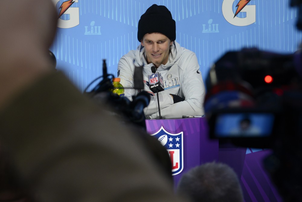 New England Patriots quarterback Tom Brady speaks with members of the press during the Super Bowl LII Opening Night event at the Xcel Energy Center on Monday.