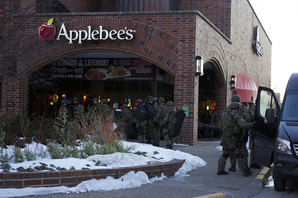 SWAT personnel gathered outside the Graduate Hotel early Monday morning in response to the standoff.