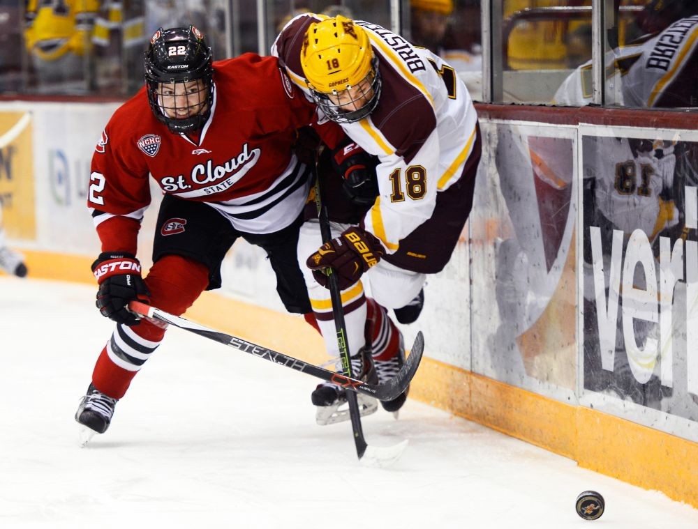 Gophers forward Leon Bristedt struggles to hold the puck against St. Cloud State defender Jimmy Schuldt at Mariucci Arena on Friday, Nov. 27, 2015.