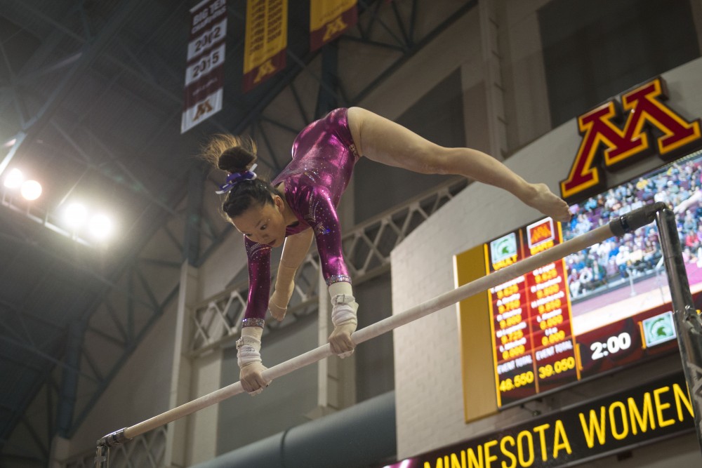 Sophomore Ivy Lu performs her bars routine at the Maturi Pavilion on Saturday, Jan. 20. The Gophers defeated the Michigan State Spartans 196.075 to 194.925.