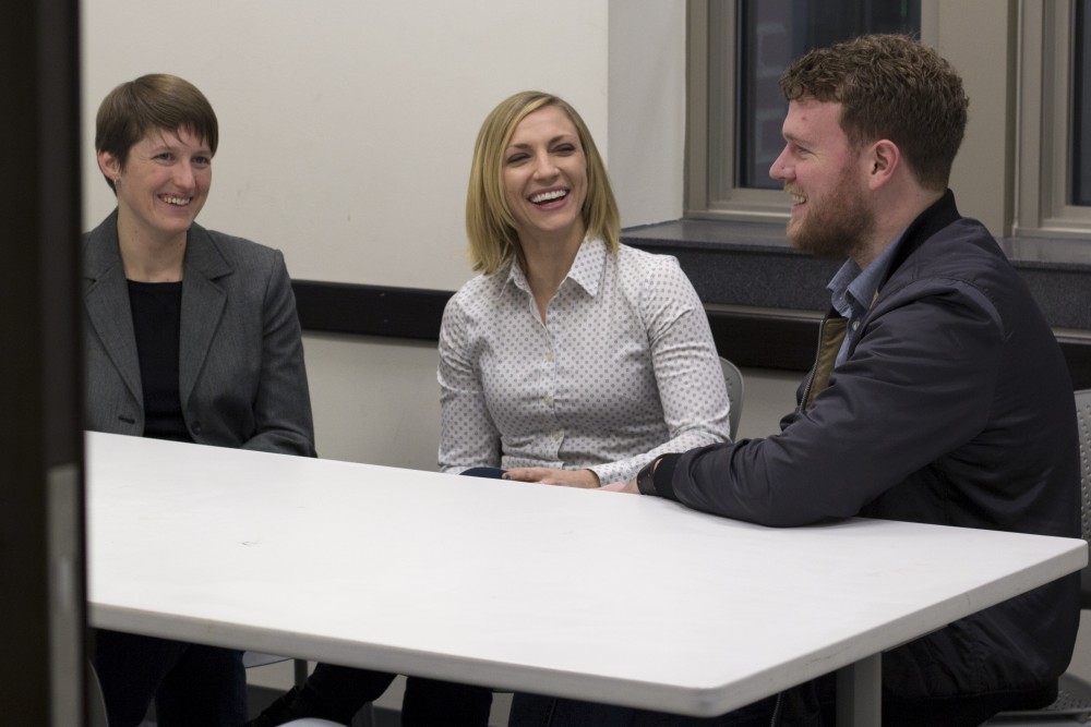 Candidates for Professional Student Government President Sonya Ewert, left, Alanna Pawlowski, and Michael Sund chat while posing for portraits in Coffman Memorial Union on Monday. 