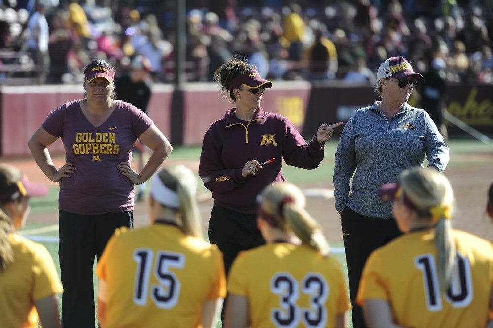 Gophers softball head coach Jamie Trachsel speaks to players of the team.