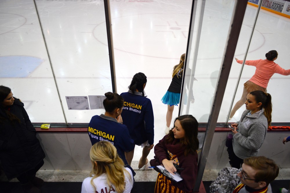 Skaters enter the ice rink to warm up before competition at the first-ever collegiate-level skating competition at 3M Arena at Mariucci on Sunday, Feb. 11.