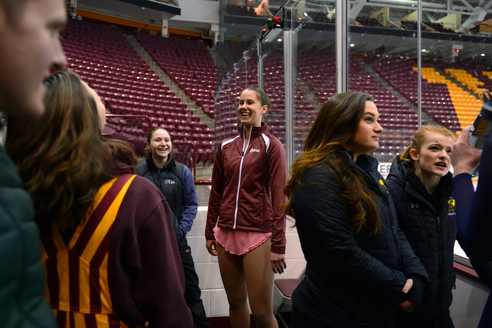 Olivia Kaus waits with teammates before competing in the Novice Free Skate group during the collegiate-level skating competition at 3M Arena at Mariucci on Sunday, Feb. 11.