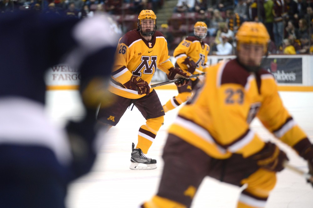 Forward Darian Romanko, center, eyes the puck during a game against Penn State at 3M at Mariucci Arena Feb. 4, 2017.
