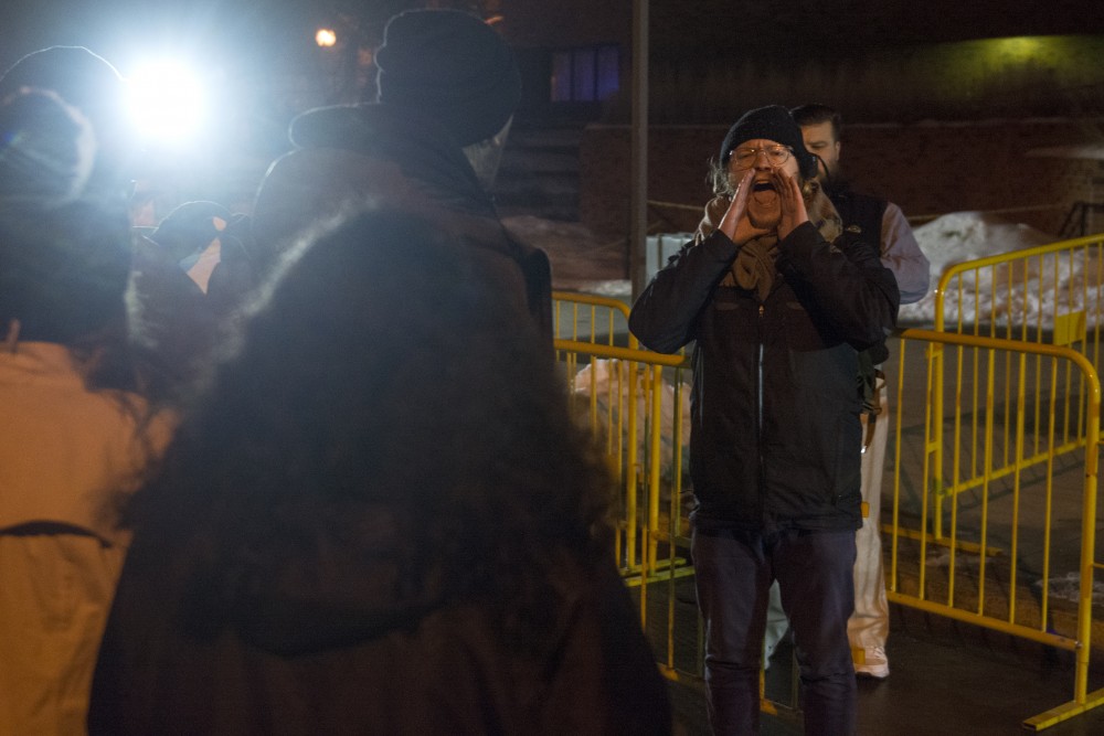 Skyler Dorr leads chants in opposition to conservative commentator Ben Shapiros appearance on campus out side the St.Paul Student Center on Monday, Feb. 26.