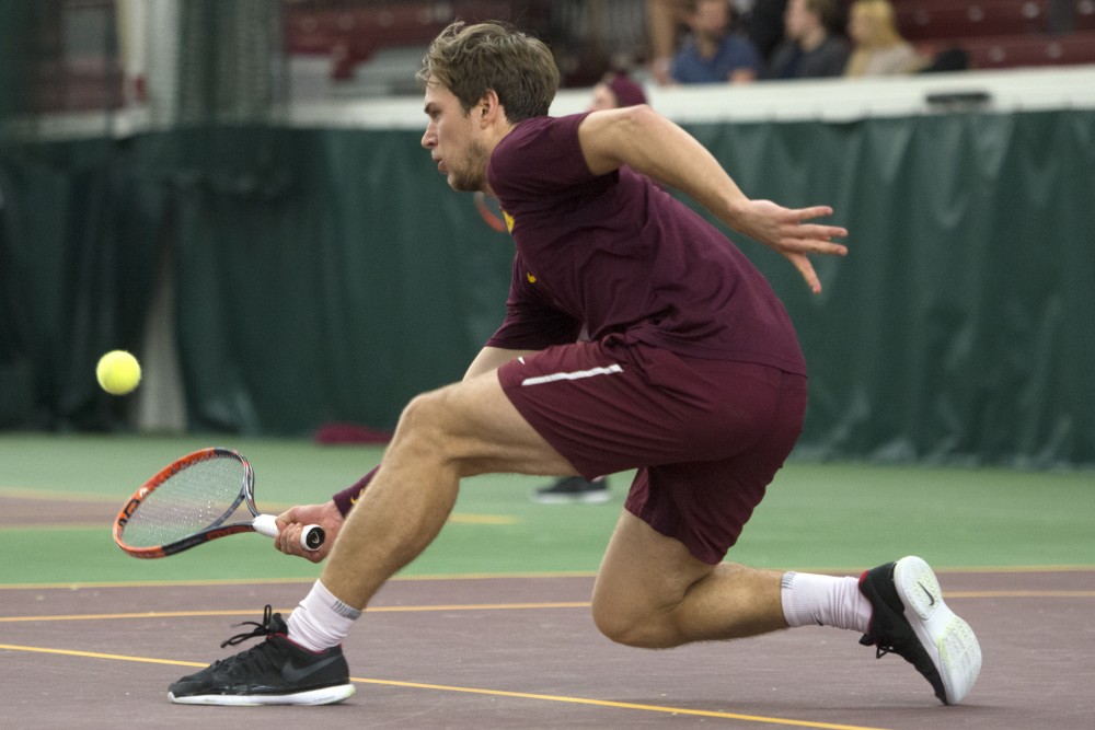Senior Matic Spec returns the ball during his singles match against the University of Pennsylvania at the Baseline Tennis Center on Sunday, Feb. 25.