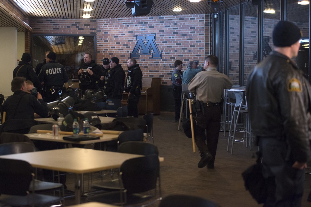 Police officers gather in the St. Paul Student Center on Monday, Feb. 26 in response to a crowd of protestors outside. The protestors were gathered in opposition of conservative commentator Ben Shapiros presence on campus. 