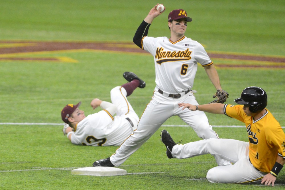 Gophers shortstop Terrin Vavra turns a double play against Iowa on March 5, 2017 at U.S. Bank Stadium. 