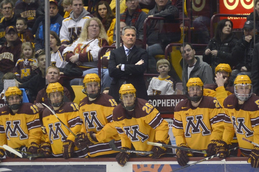 Gophers players and head coach Don Lucia follow the game at 3M Arena at Mariucci on Saturday, Feb. 7, 2015.