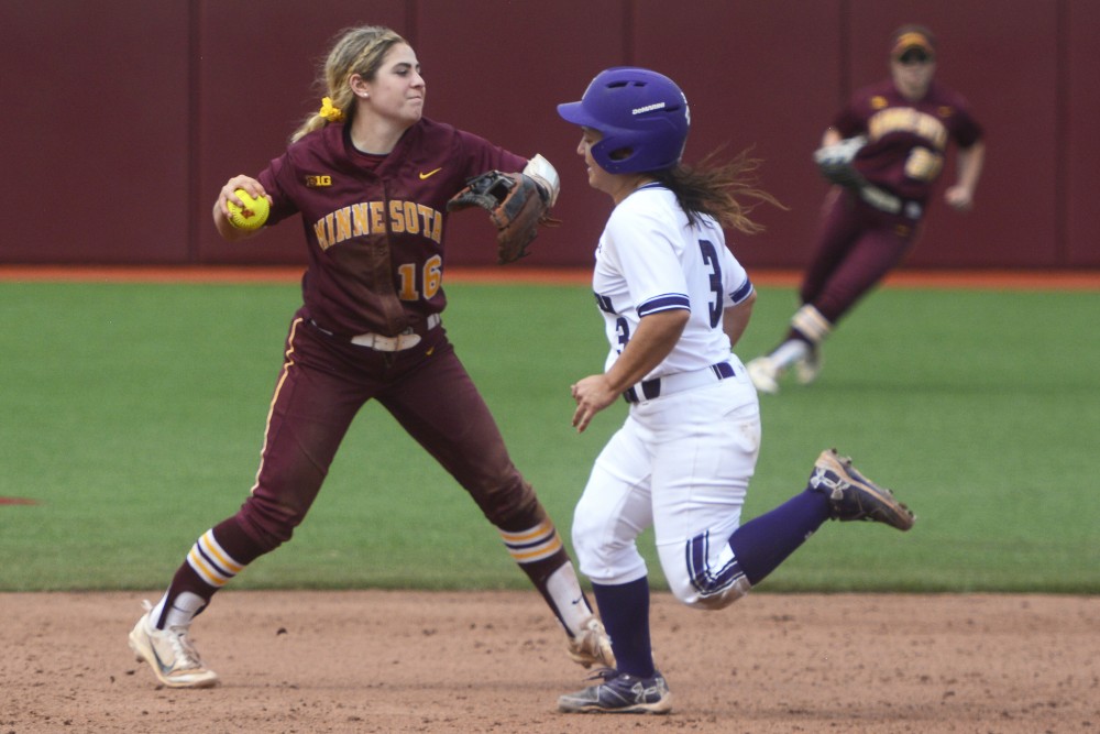 Infielder Allie Arneson throws to first base during a game against Northwestern on April 15, 2017 at Jane Sage Cowles Stadium.