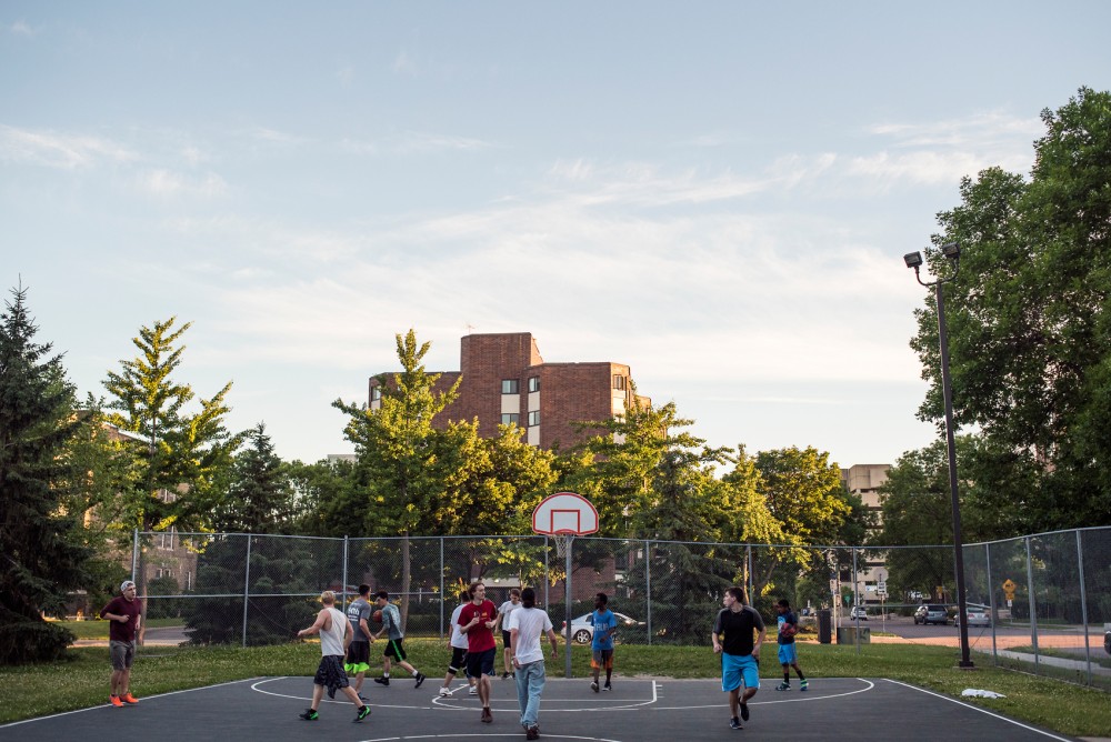 A group plays a game of pick-up basketball at Holmes Park located in the Marcy-Holmes neighborhood of Minneapolis on June 22, 2016.