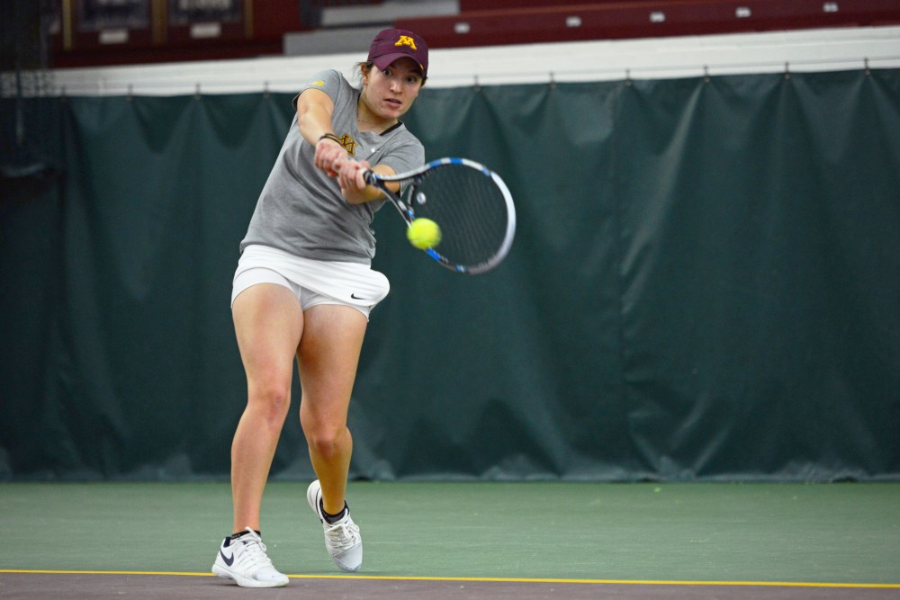Junior Caitlyn Merzbacher returns the ball during her singles match against the University of South Dakota at the Baseline Tennis Center on Friday, Feb. 9. 