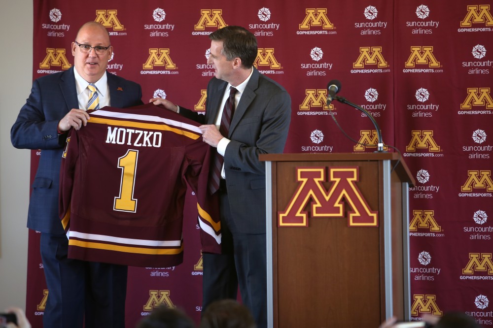 New mens hockey coach Bob Motzko accepts his first Gophers jersey from athletics director Mark Coyle at a press conference on Thursday, March 29.
