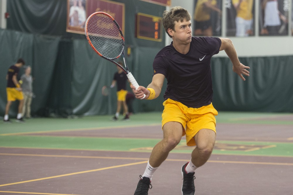 Senior Matic Spec returns the ball during a game against Ohio State at Baseline Tennis Center on Friday, March 30.